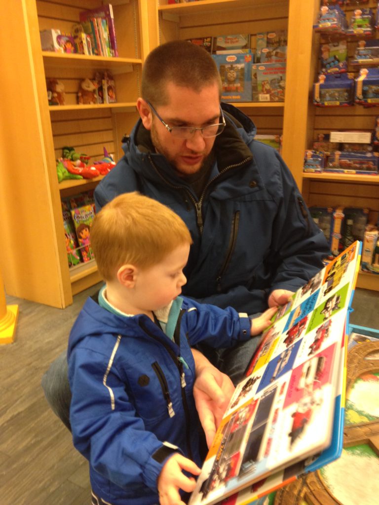 Mr. E reading with dad