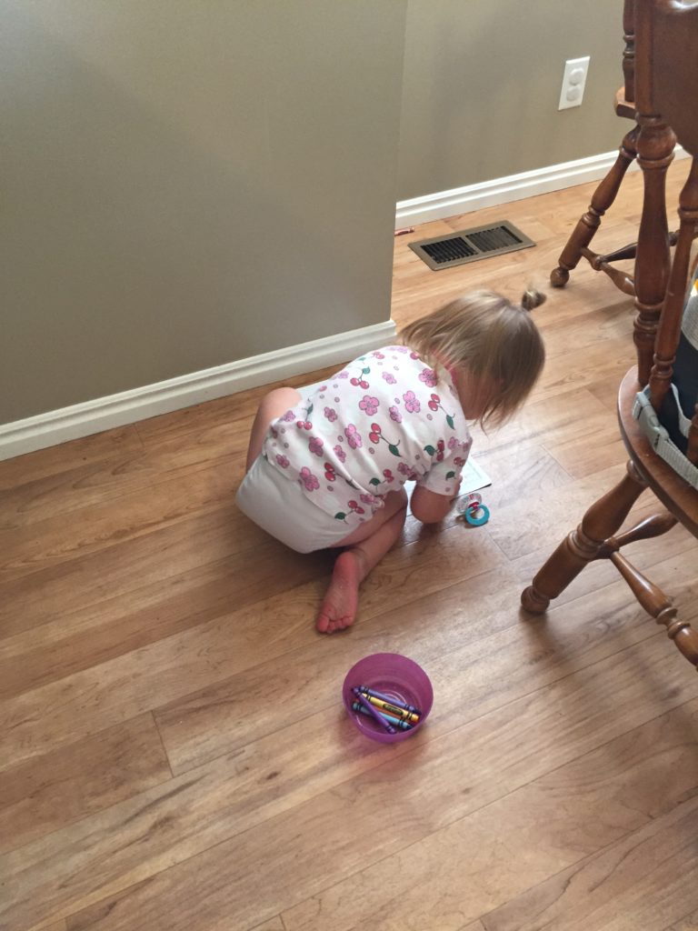 Miss S coloring on the floor